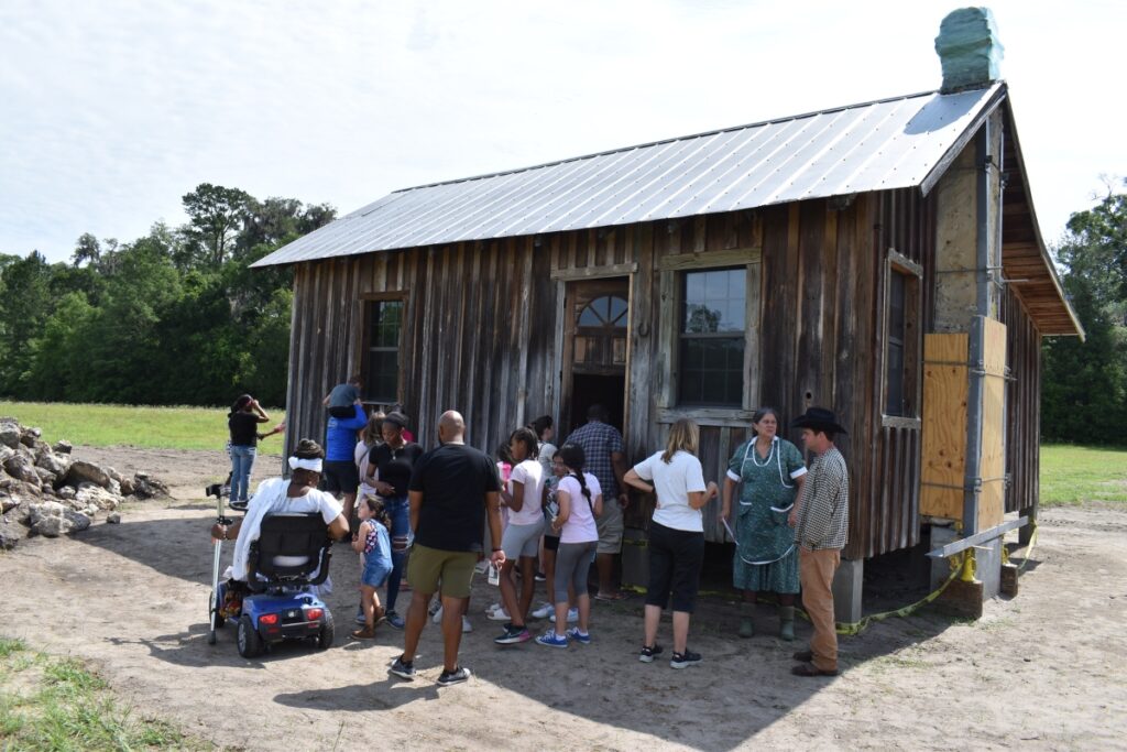 Attendees look into the Perkins house after Saturday's ceremony.